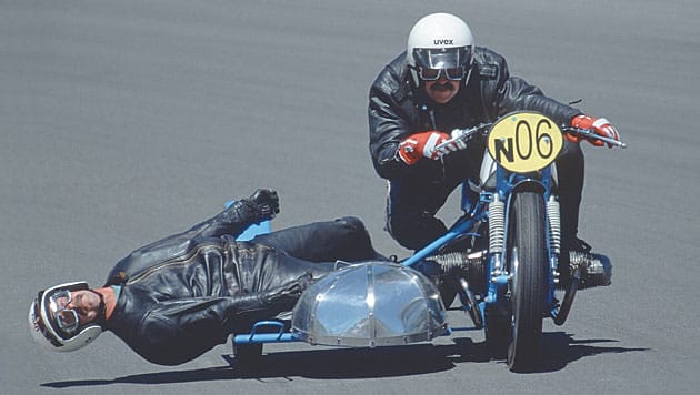 George Guski skims the surface as Herbert Grod drives their 1955 BMW into a turn during a vintage sidecar race at the 'Ring.